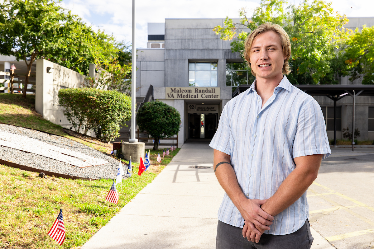 Elliot Luedtke poses for a photo outside of the Malcom Randall Veteran Affairs Medical Center in Gainesville, FL.